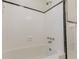 Clean white bathtub with black trim, white tiled walls, and modern fixtures at 43 Lott Se Ave, Marietta, GA 30067