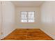 Bright bedroom featuring classic wood paneling, wood floors, and a large window for natural light at 43 Lott Se Ave, Marietta, GA 30067