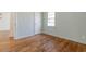 Inviting bedroom features hardwood floors, light green walls, and a bright window at 43 Lott Se Ave, Marietta, GA 30067