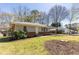 View of the home with a well-maintained lawn and mature trees at 43 Lott Se Ave, Marietta, GA 30067