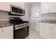 Well-lit kitchen featuring stainless steel appliances, and granite countertops at 43 Lott Se Ave, Marietta, GA 30067