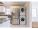 Modern kitchen with stainless steel appliances and granite countertops and stackable washer and dryer at 43 Lott Se Ave, Marietta, GA 30067