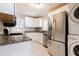 Bright kitchen with white cabinets, granite countertops, and modern stainless steel appliances at 43 Lott Se Ave, Marietta, GA 30067