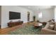 Modern living room with a large TV, stylish console, hardwood floors, and contemporary decor at 43 Lott Se Ave, Marietta, GA 30067