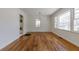 Open-concept living room with hardwood floors, white walls, and access to the laundry and backyard at 43 Lott Se Ave, Marietta, GA 30067
