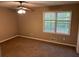Well-lit bedroom featuring neutral walls, a window providing natural light and plush carpeting at 1106 Hardy Cir, Dallas, GA 30157