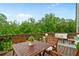 Spacious wooden back deck, ideal for outdoor relaxation and entertaining with lush greenery at 13 Oakside Nw Ct, Cartersville, GA 30121