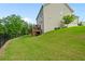 Large grassy backyard with a black fence and wood deck; perfect for outdoor enjoyment and privacy at 13 Oakside Nw Ct, Cartersville, GA 30121