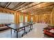 Expansive unfinished basement offering potential for customization, with ping pong table and seating at 13 Oakside Nw Ct, Cartersville, GA 30121