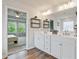Elegant bathroom with double vanity, sleek white cabinets, and modern fixtures and access to main bedroom at 13 Oakside Nw Ct, Cartersville, GA 30121