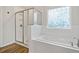 Modern bathroom featuring a separate shower, soaking tub, and stylish window at 13 Oakside Nw Ct, Cartersville, GA 30121