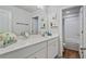 Well-lit bathroom featuring a dual sink vanity with white countertops, a large mirror, and a separate shower and toilet room at 13 Oakside Nw Ct, Cartersville, GA 30121