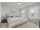 Comfortable bedroom with soft carpet, a queen-sized bed, matching nightstands, and dual windows dressed with floral curtains at 13 Oakside Nw Ct, Cartersville, GA 30121