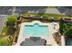 Aerial view of a rectangular community pool with sunbathing area and landscaping at 13 Oakside Nw Ct, Cartersville, GA 30121
