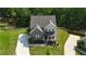 Aerial view showcases a charming two-story brick home with a well-kept lawn and inviting front porch at 13 Oakside Nw Ct, Cartersville, GA 30121