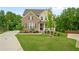 Traditional brick and siding home with a welcoming front porch and manicured lawn at 13 Oakside Nw Ct, Cartersville, GA 30121