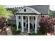 Elegant brick home featuring prominent columns, mature landscaping, and a circular driveway at 13 Oakside Nw Ct, Cartersville, GA 30121