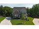 Aerial view showcases a charming two-story brick home with a well-kept lawn and inviting front porch at 13 Oakside Nw Ct, Cartersville, GA 30121