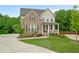 Attractive two-story brick home with a covered front porch and professionally landscaped front yard at 13 Oakside Nw Ct, Cartersville, GA 30121