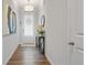Entry hallway boasting hardwood floors, a modern light fixture, and console table with an eye-catching piece of artwork at 13 Oakside Nw Ct, Cartersville, GA 30121