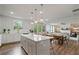 Open-concept kitchen and dining area with a large island, stylish pendant lights, and a seamless flow to the living room at 13 Oakside Nw Ct, Cartersville, GA 30121