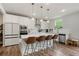 Modern white kitchen featuring a large island with seating, stainless steel appliances, and sleek countertops at 13 Oakside Nw Ct, Cartersville, GA 30121