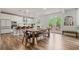 Spacious kitchen with stainless steel appliances, white cabinets, and a large wooden dining table at 13 Oakside Nw Ct, Cartersville, GA 30121