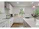 Well-lit kitchen featuring white cabinets, stainless steel appliances, and stylish fixtures at 13 Oakside Nw Ct, Cartersville, GA 30121
