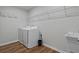 Functional laundry room equipped with a washer and dryer, complemented by overhead shelving and a utility sink at 13 Oakside Nw Ct, Cartersville, GA 30121