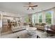 Bright and airy living room with large windows, comfortable seating, and an open layout to the kitchen at 13 Oakside Nw Ct, Cartersville, GA 30121