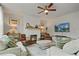 Inviting living room with a cozy fireplace, modern ceiling fan, and comfortable seating arrangement at 13 Oakside Nw Ct, Cartersville, GA 30121