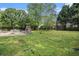 Large backyard with green grass, a fence, and an outdoor grilling area at 1608 Drakes Dr, Jonesboro, GA 30236