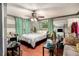 This bedroom features a ceiling fan, curtains, and a window at 1608 Drakes Dr, Jonesboro, GA 30236