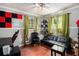 Bedroom featuring a ceiling fan, futon, desk and decorative sound dampening squares at 1608 Drakes Dr, Jonesboro, GA 30236