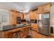 Well-equipped kitchen featuring an island, stainless steel appliances, custom wood cabinets, and black countertops at 1608 Drakes Dr, Jonesboro, GA 30236