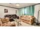 Living room featuring tiled flooring, chandeliers, and 3 sofas at 1608 Drakes Dr, Jonesboro, GA 30236