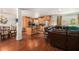Open-concept living and dining area with hardwood floors, stainless steel appliances, and an eat-in island at 1608 Drakes Dr, Jonesboro, GA 30236