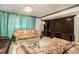 Living room features tiled flooring, chandeliers, 3 sofas and a large cabinet at 1608 Drakes Dr, Jonesboro, GA 30236