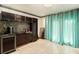 Spacious living room with tiled flooring, chandeliers, long curtains, and a wet bar at 1608 Drakes Dr, Jonesboro, GA 30236