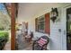 Inviting covered porch with seating area, decorative shutters, and a vintage-style lantern at 1608 Drakes Dr, Jonesboro, GA 30236