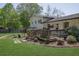Relaxing backyard with a deck, patio, and lush green lawn, ideal for outdoor entertaining at 3935 Manor House Dr, Marietta, GA 30062