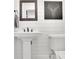 Elegant bathroom with a pedestal sink, modern fixtures, and white shiplap walls at 3935 Manor House Dr, Marietta, GA 30062