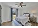 Cozy bedroom with a ceiling fan, bedside table, and natural light from the window at 3935 Manor House Dr, Marietta, GA 30062