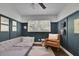 Stylish bedroom features a daybed, accent wall, reading chair, and natural light at 3935 Manor House Dr, Marietta, GA 30062