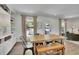 Bright dining area featuring a wooden table, bench, and views of the landscaped backyard at 3935 Manor House Dr, Marietta, GA 30062