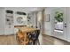 Dining area with a large wooden table, built-in shelving, and outdoor access at 3935 Manor House Dr, Marietta, GA 30062
