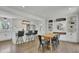 Open-concept kitchen and dining area with white cabinets and an island with bar stools at 3935 Manor House Dr, Marietta, GA 30062
