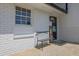 Covered porch with a bench and welcome mat leading to the front door at 3935 Manor House Dr, Marietta, GA 30062