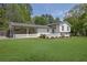 Charming white brick home with well-manicured lawn and covered carport at 3935 Manor House Dr, Marietta, GA 30062