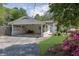 Charming home with a brick carport, manicured lawn, and colorful flowerbeds at 3935 Manor House Dr, Marietta, GA 30062